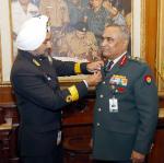 Secretary, Kendriya Sainik Board Commodore HP Singh pinning the Armed Forces Flag on Chief of the Army Staff General Manoj Pande in New Delhi on December 06, 2022 ahead of Armed Forces Flag Day. 